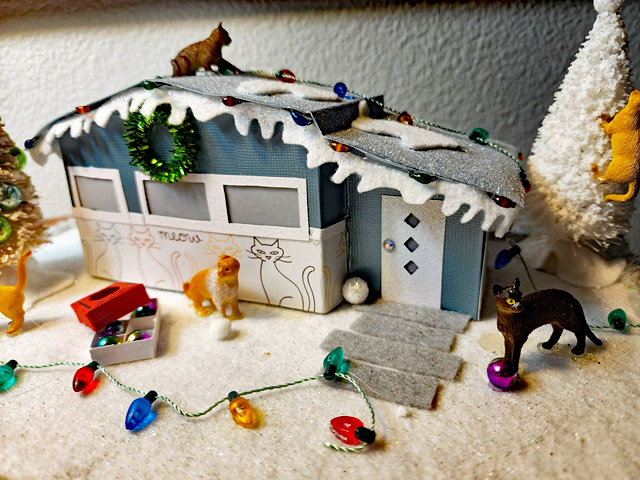 Miniature Christmas mid-century modern house with tiny cats 