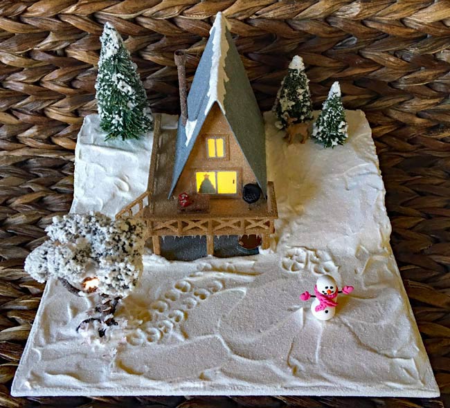 Paper Christmas house as brown A-frame cabin