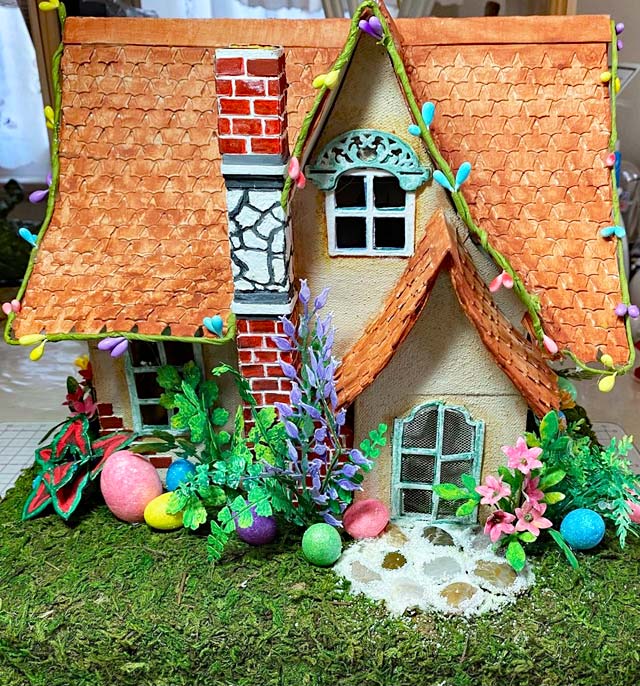 Miniature Easter house with flower garden