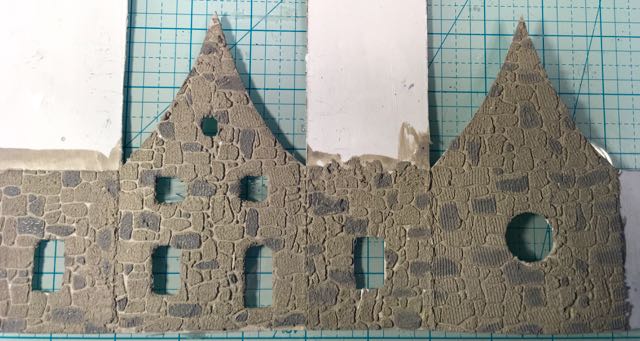 Stones painted on little house cardboard pattern