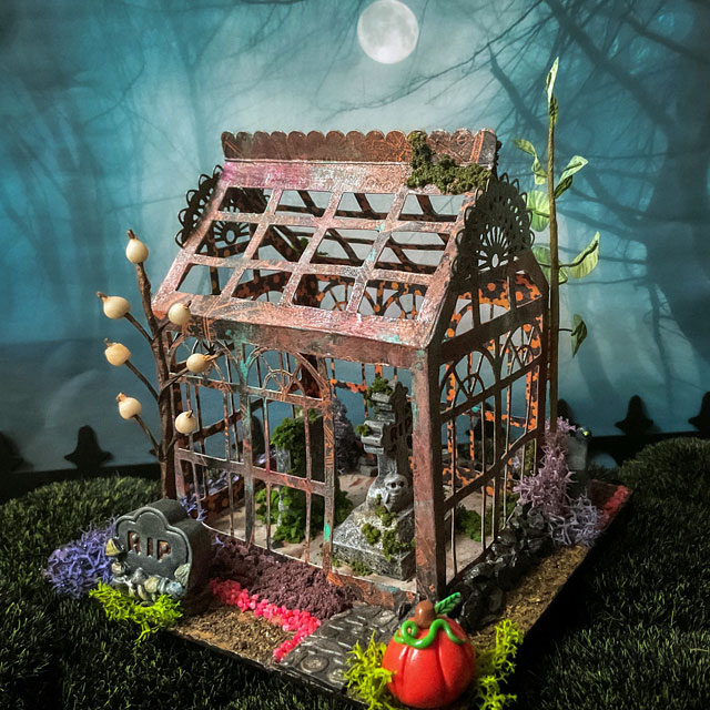 Spooky miniature greenhouse decorated for Halloween