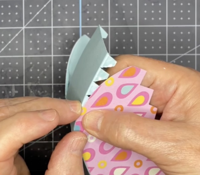 Apply glue tabs to curved side of candy basket