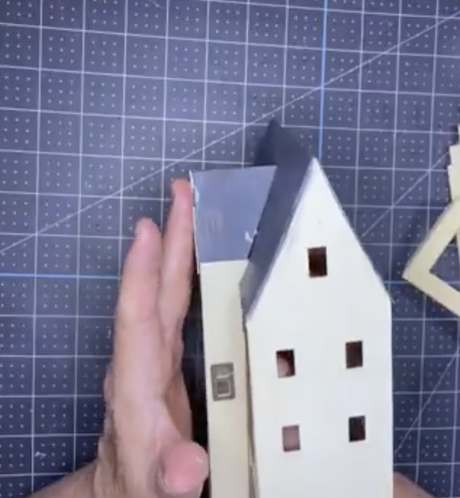Apply pressure to adhere tower roof to main roof