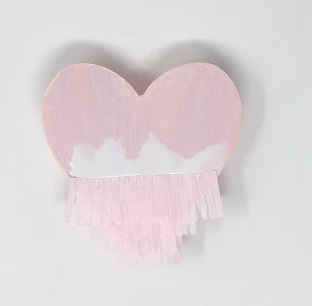 Attach fringe strip crepe paper to Valentine piñata candy box