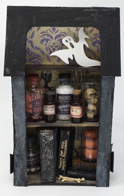 Apothecary diorama with medicinal vials and bottles, miniature spell books on the bottom shelf and a ghost haunting the attic