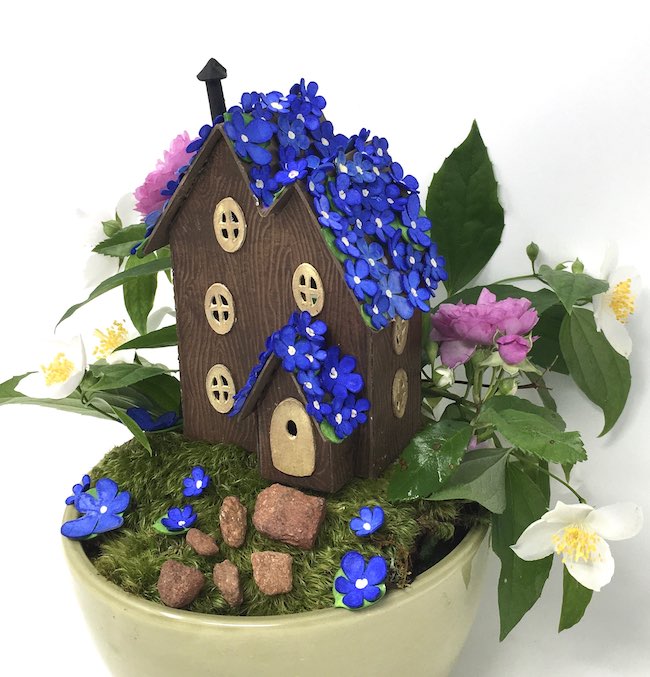 Blue blossom fairy house on mossy base