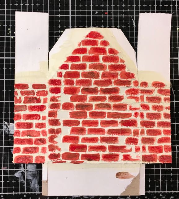 Brick stenciled surface on Christmas shadow box house