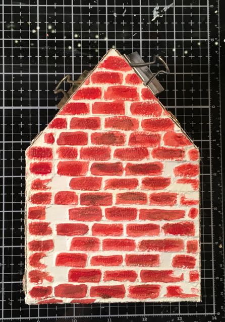 Brick stenciled surface to miniature Christmas house glued together