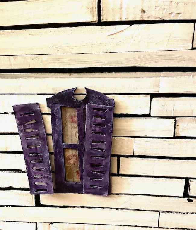Cardboard window with crooked shutters