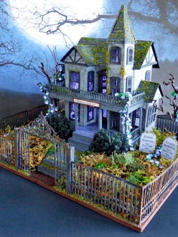 Cardboard mansion with graveyard in front yard