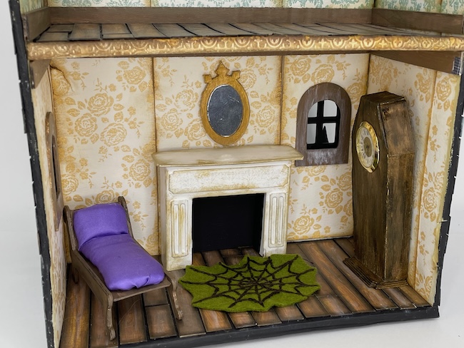 Chaise lounge in dollhouse with wallpaper