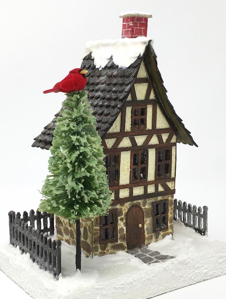 Christmas Village house with a custom bottlebrush tree with cardinal on top