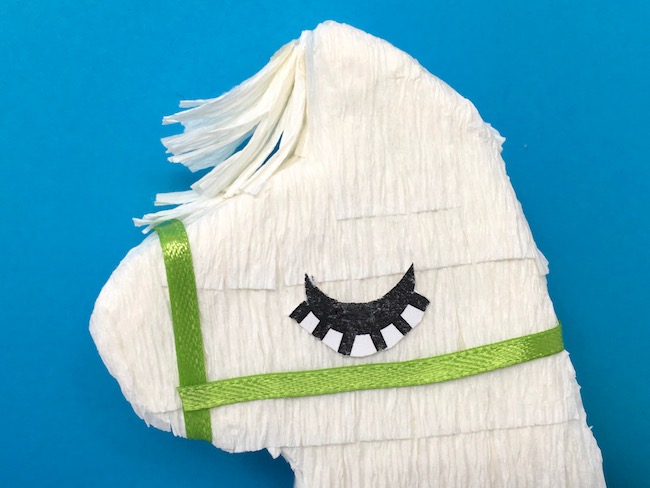 Close-up of eyelashes on mini llama pinata