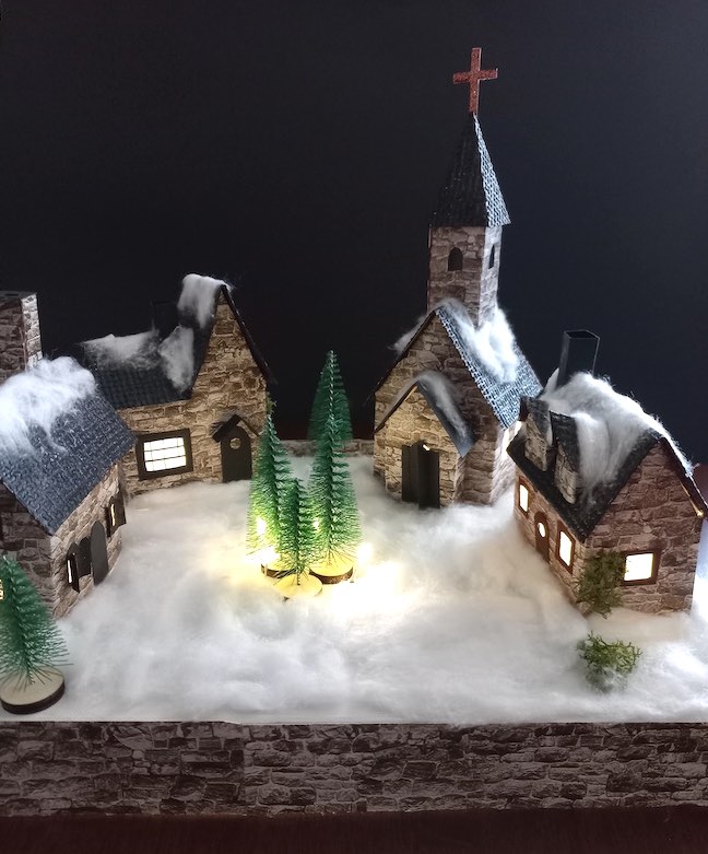 Cardboard Christmas village with dark background