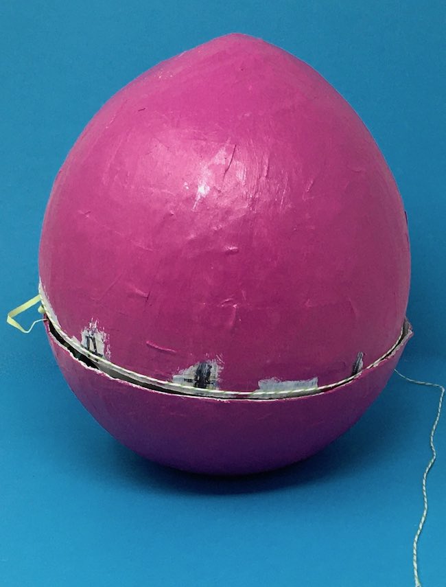 Cut the egg to create opening glue on string