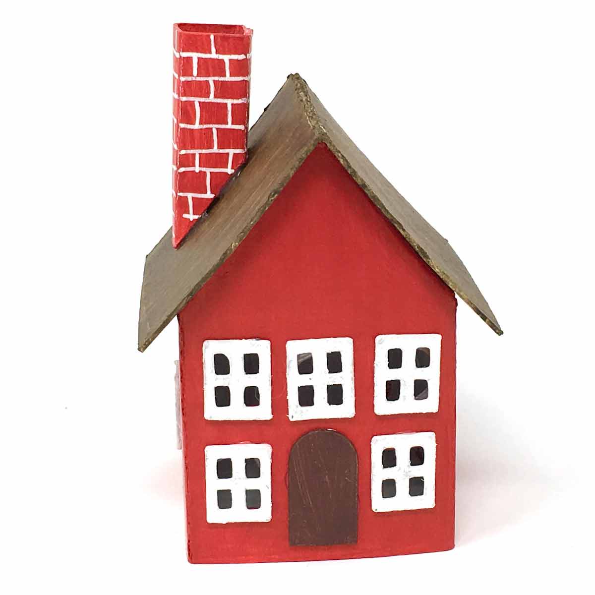 Tiny paper house painted in red with brown roof and red chimney