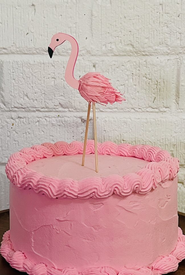 Flamingo cake topper on fake cake