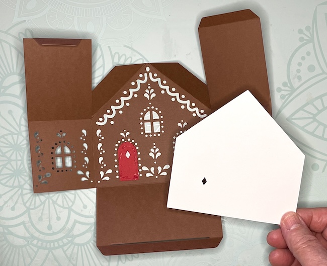 Glue background piece to gingerbread gift box