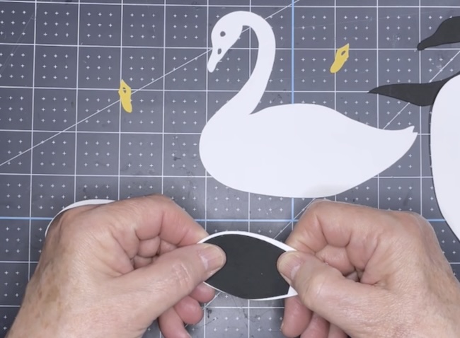 Glue black wing piece behind wing