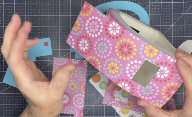 Glue decorative papers to camper roof