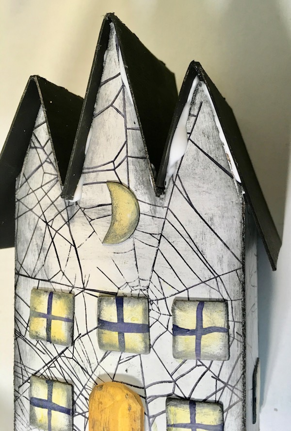 Glue roof pieces on triple gable gothic halloween paper house