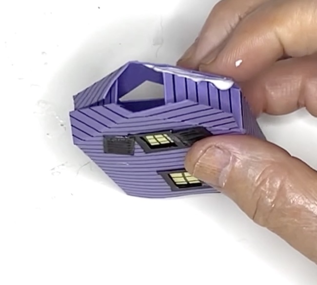 Apply glue to glue tab on Haunted House front extension