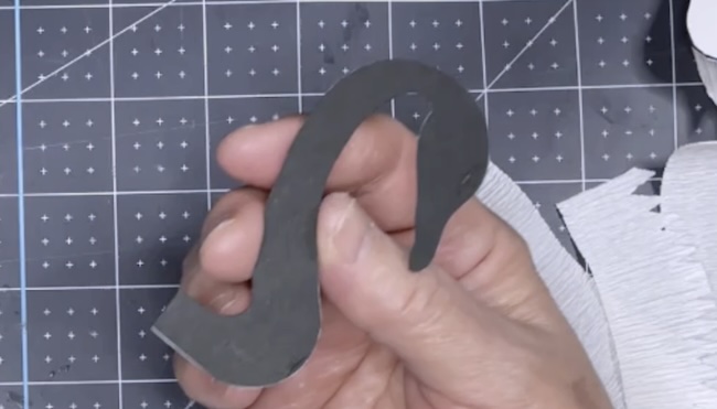 Glue the black neck piece behind white swan neck