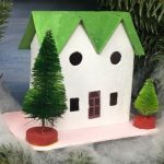 Green twin gable house in Christmas wreath