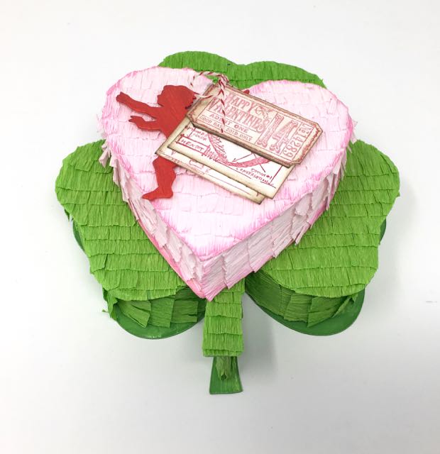 Heart-shaped pinata candy box on top of shamrock candy box