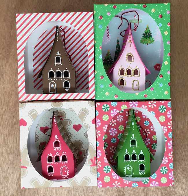 Holiday paper house ornaments in display boxes