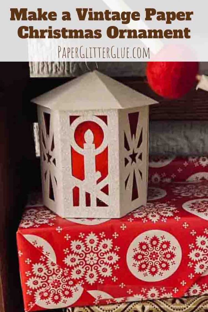 Vintage white Christmas ornament on wrapped red present