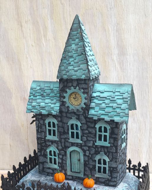 Stone Stencil Clock House - Halloween house with a stone-like surface and shingled roof #putzhouse #halloween #papercraft