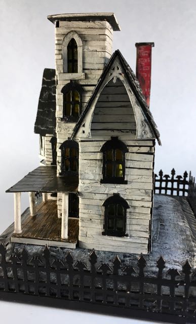 Italianate Halloween House porch side view. Yes, hand cut trim around that gable too. #halloweenhouse #halloween #putzhouse #papercraft