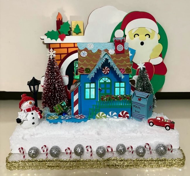 Christmas house with Santa in background