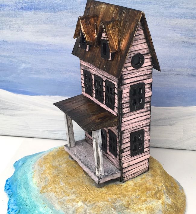 Little pink cardboard beach house in progress on cardboard base