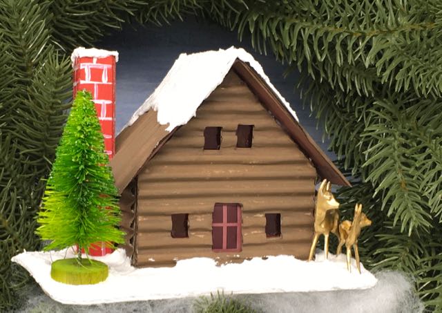 Log cabin putz house angled with deer bottlebrush tree