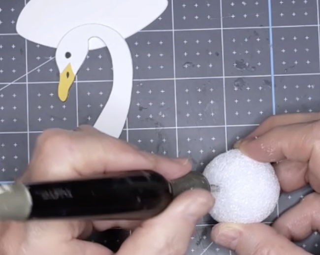 Make a cut in styrofoam ball large enough to insert neck