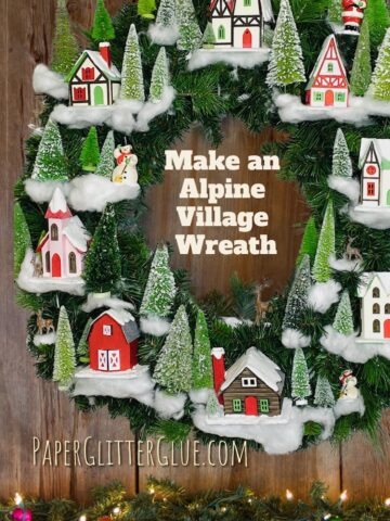 Wreath with alpine village houses and bottlebrush trees