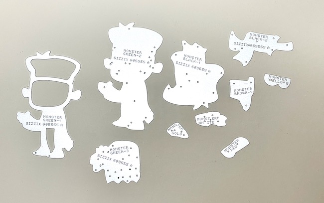 Silver die pieces on tan background to make a halloween paper figure 