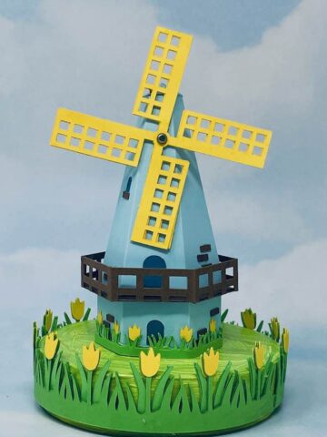 Blue and yellow paper dutch windmill on tulip base