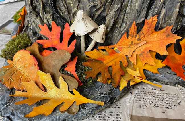 Paper leaves at base of paper mache tree stump