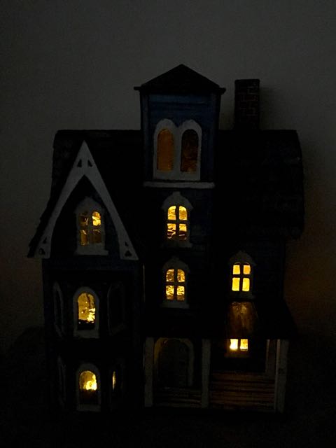 Photo of little putz house in dark with lights on