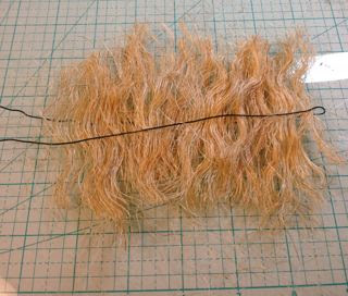 Place sisal fibers centered between folded wire