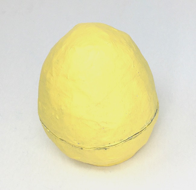 Primed and painted yellow paper mache egg