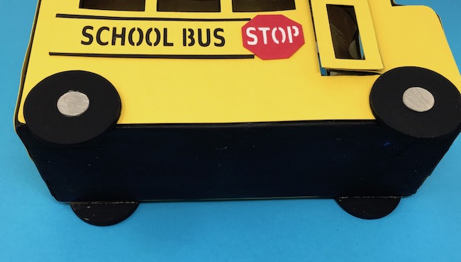 School bus on side showing wheels glued on