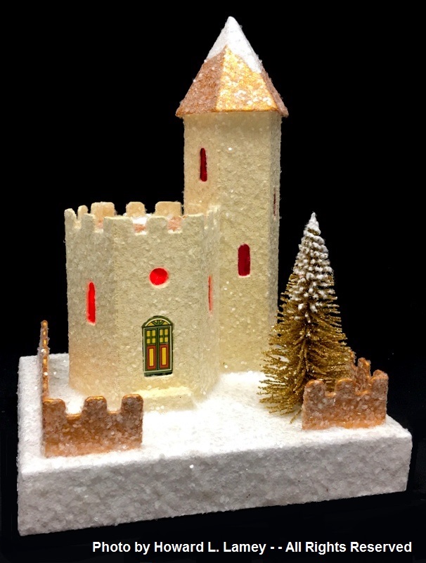 Glittery yellow castle with gold steeple on tower