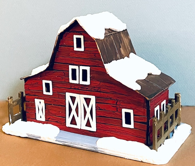 Red barn with snow on the roof