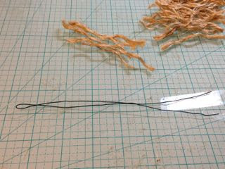 Straighten wire for bottle brush tree trunk and fold in half