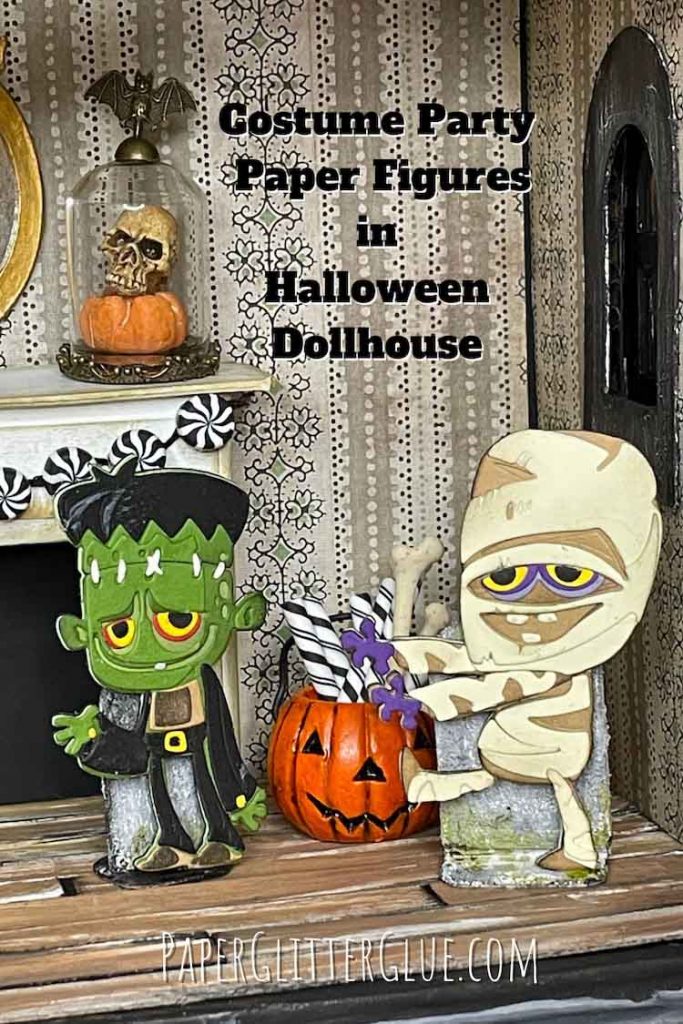 Paper Mummy and Monster in Halloween dollhouse with orange pumpkin behind