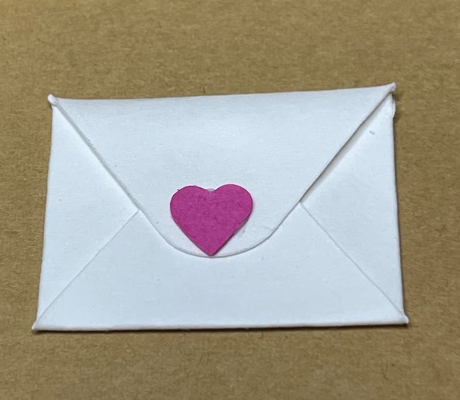 Tiny paper envelope with heart on back flap
